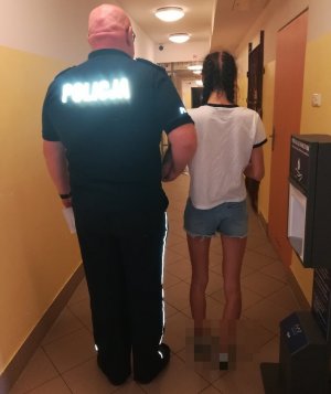 policjant z zatrzymaną w korytarzu