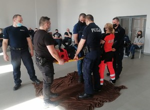 uczestnicy podczas szkolenia z pierwszej pomocy transportują osobę poszkodowaną