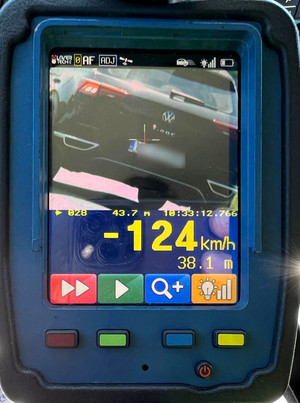 widoczne urządzenie do pomiaru prędkości, na którego wyświetlaczu widoczne jest pojazd jadący z prędkością 124 km/h