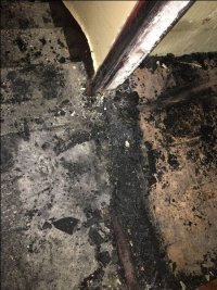 na zdjęciu fragment nadpalonej futryny drzwi wejściowych