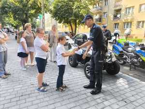 Policjanci podczas przekazywania elementów odblaskowych.