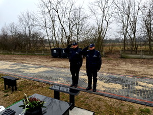 Policjanci oddający hołd zmarłemu koledze.