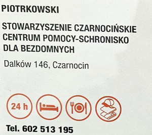 Plakat z danymi schroniska dla osób w kryzysie bezdomności.
