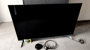 Telewizor i leżący obok niego dekoder.