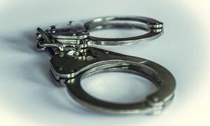 Metalowe kajdanki na białym tle.