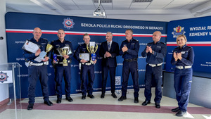 Sierżant Mateusz Kowalski wraz z policjantami którzy zajęli drugie i trzecie miejsce oraz Zastępca Komendanta Wojewódzkiego Policji w Łodzi młodszy inspektor Mariusz Siejka, Naczelnika Wydziału Ruchu Drogowego KWP w Łodzi podinspektor Jarosław Złotkowski, Dyrektor Wojewódzkiego Ośrodka Ruch Drogowego w Łodzi Michał Gogolewski oraz Sędzia Główny konkursu aspirant Aneta Błędniak-Kałka z Wydziału Ruchu Drogowego Komendy Wojewódzkiej Policji w Łodzi.